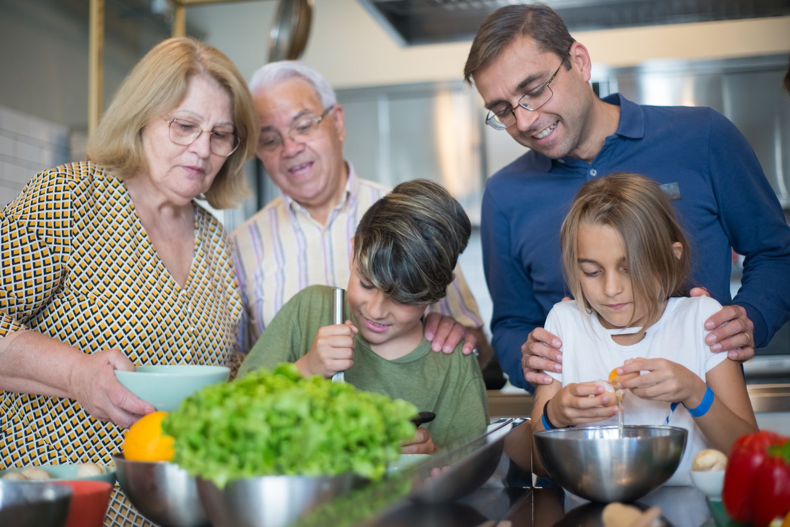 Three generations of a family cooking together in the kitchen