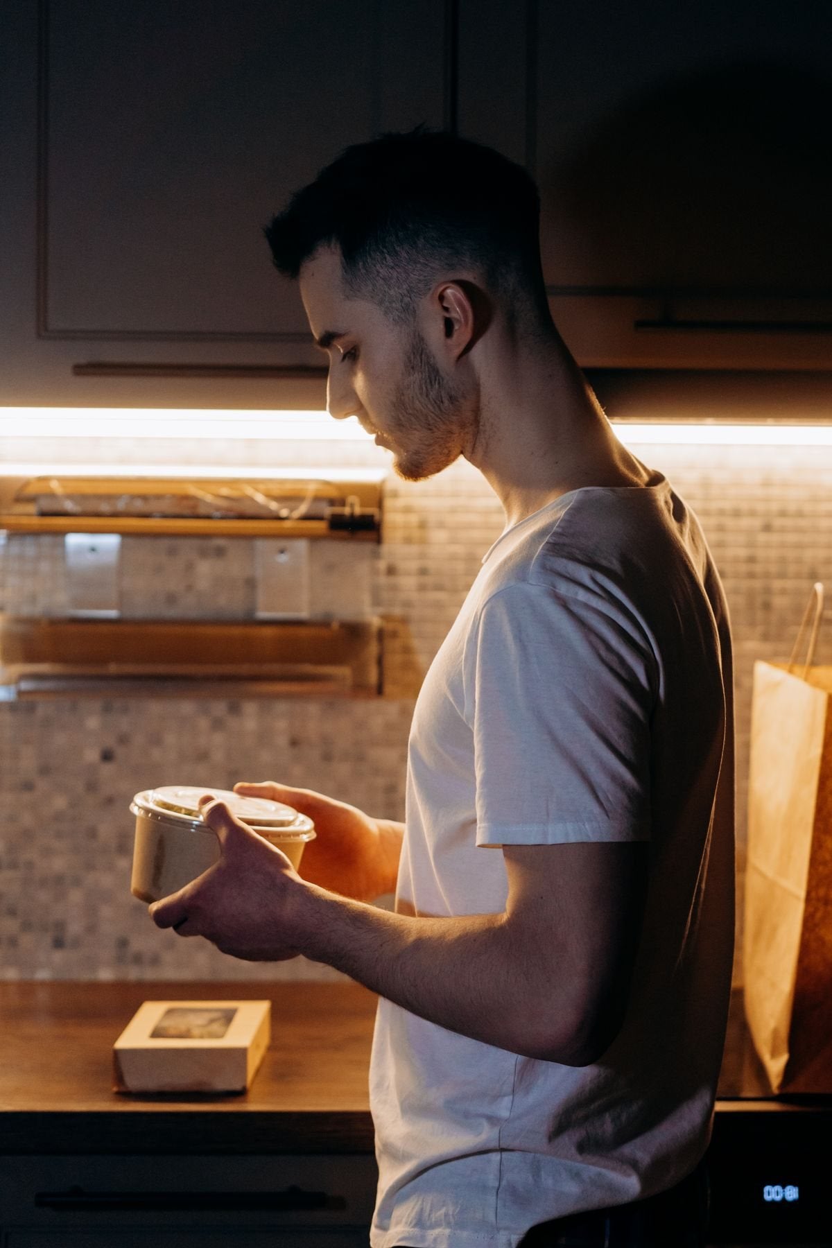 A student cooking in a shared apartment kitchen